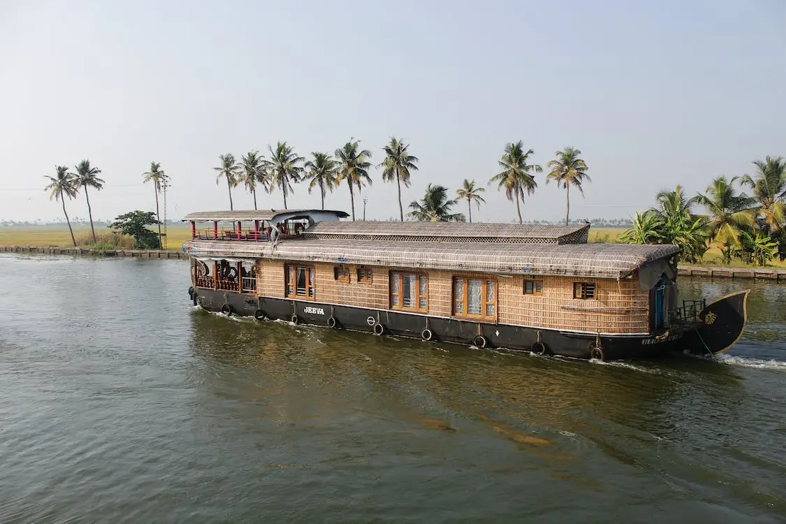 Traditional houseboat cruising through the scenic backwaters of Alleppey, Kerala.
